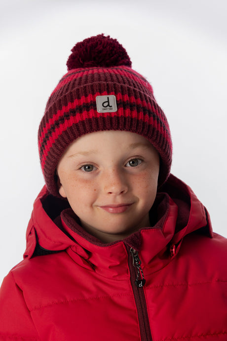 Deux par Deux boys' burgundy striped pompom hat – worn by a model