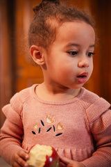 Child in the Deux par Deux pink knit sweater dress, lifestyle photo