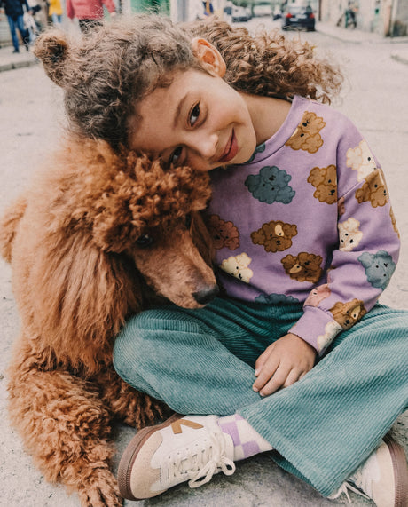 Child in the Deux par Deux purple poodle sweatshirt, lifestyle photo