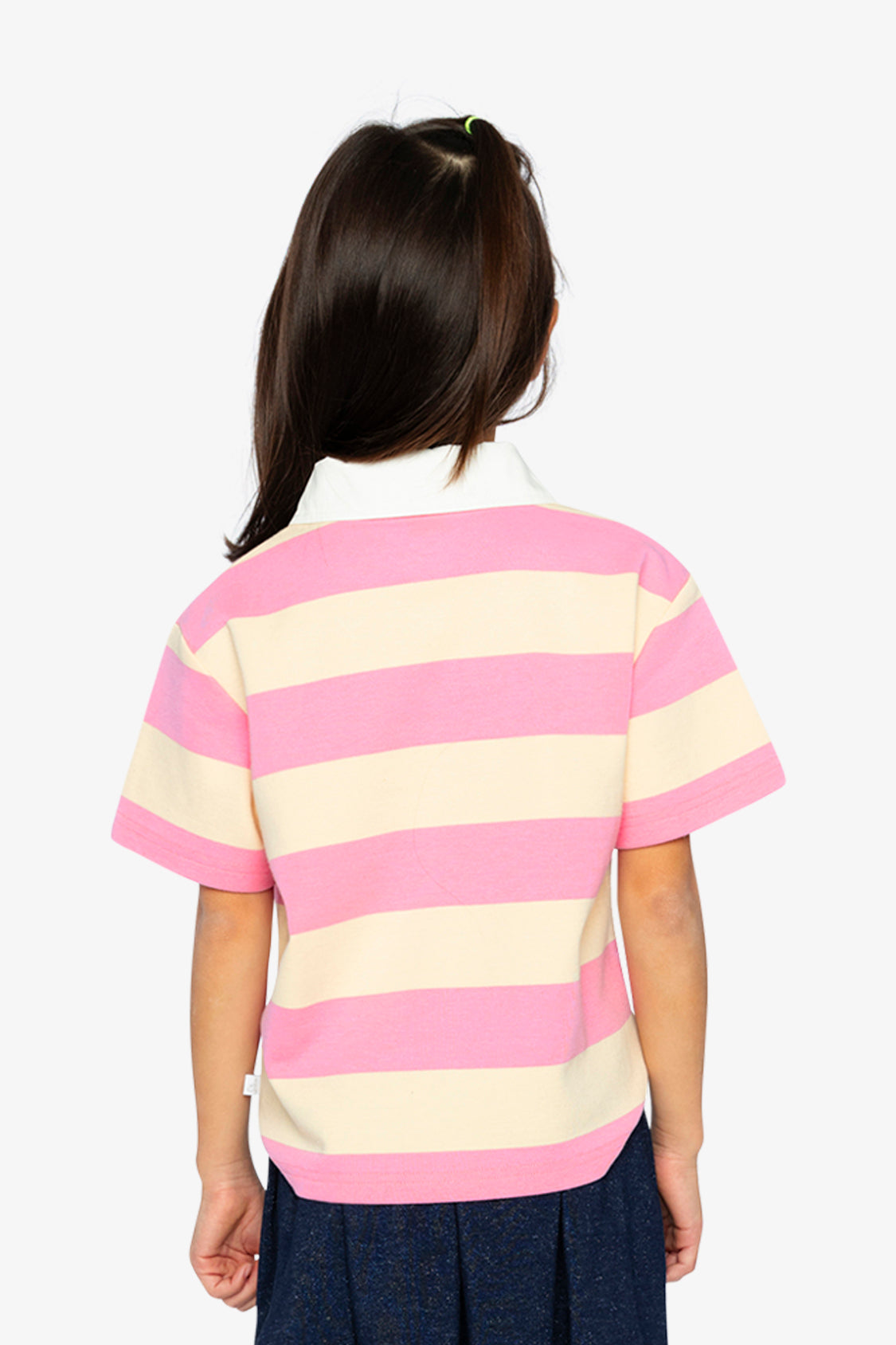 Back view of a child wearing the pink and beige striped polo shirt