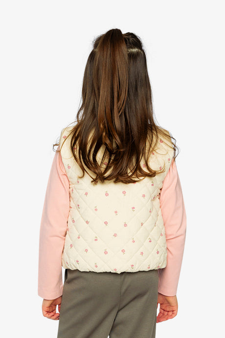 Child wearing the quilted beige corduroy vest with prairie flower print