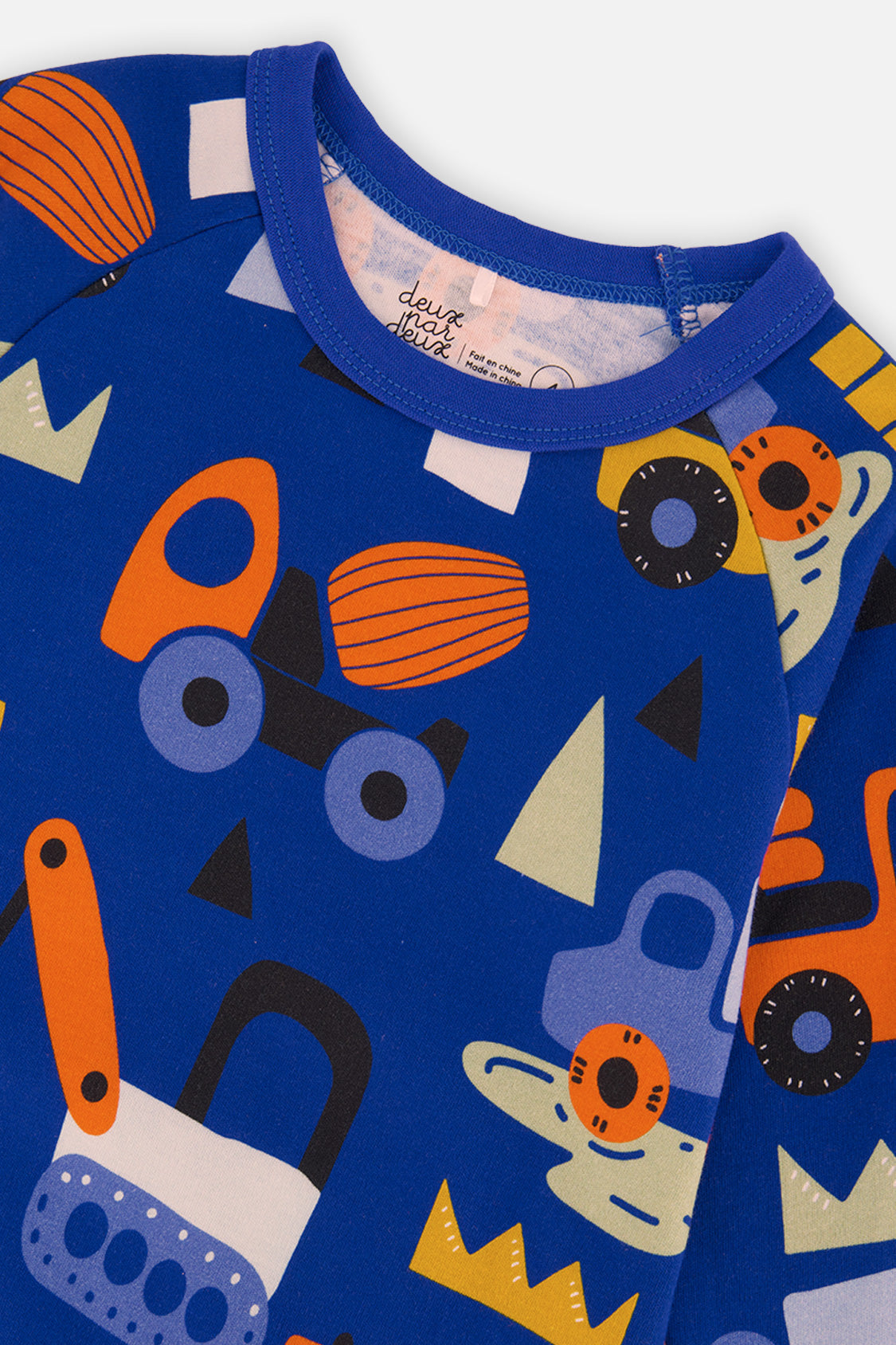 Close-up detail of the Deux par Deux blue truck print organic cotton pajama set