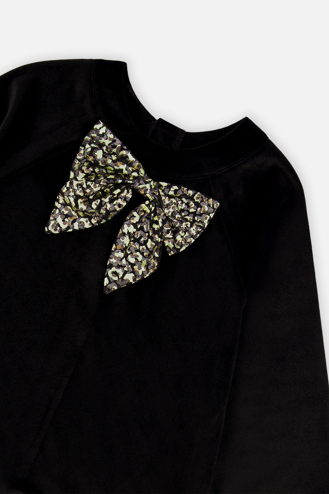 Close-up of the leopard print bow on the black velour bodice of the Deux par Deux dress