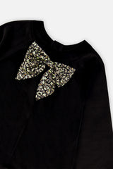 Close-up of the leopard print bow on the black velour bodice of the Deux par Deux dress