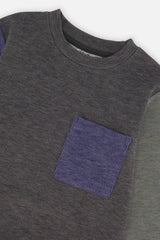 Close-up of the ribbed crew neck and blue patch pocket on the charcoal knit