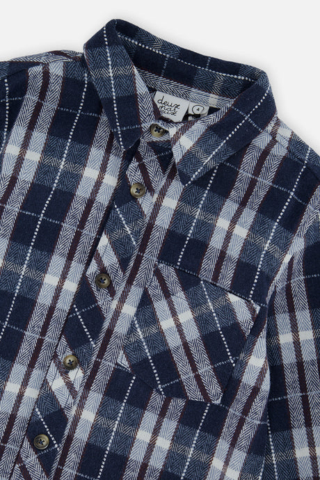 Close-up of the collar, buttons and chest patch pocket on the blue and white plaid flannel shirt