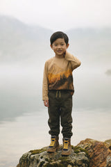 Child wearing the Deux par Deux beige organic cotton long-sleeve tee, lifestyle view
