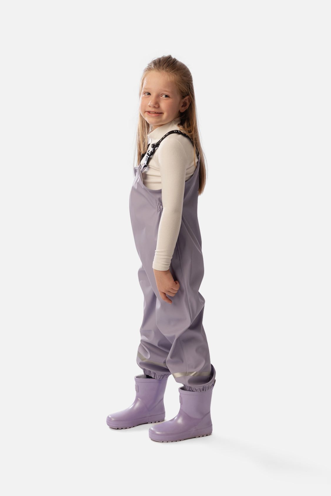 Child wearing the Deux par Deux mauve rain overalls, lookbook shot