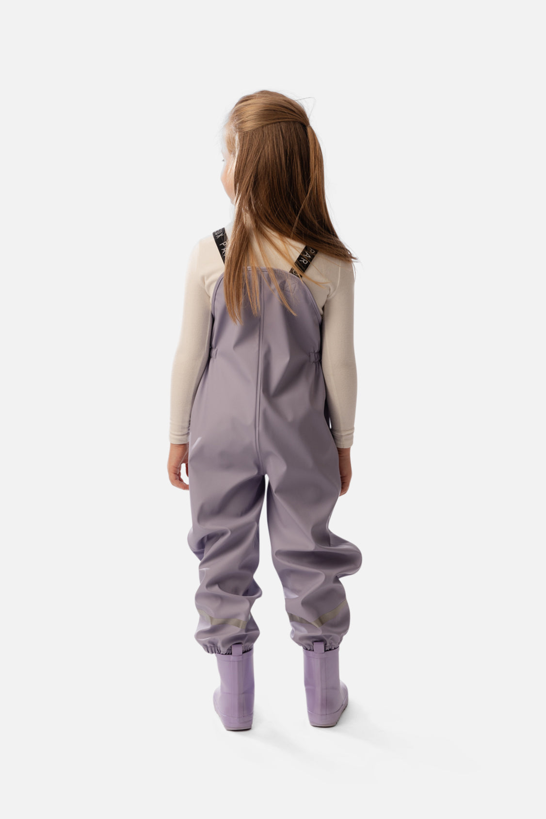 Child wearing the Deux par Deux mauve rain overalls, second lookbook shot