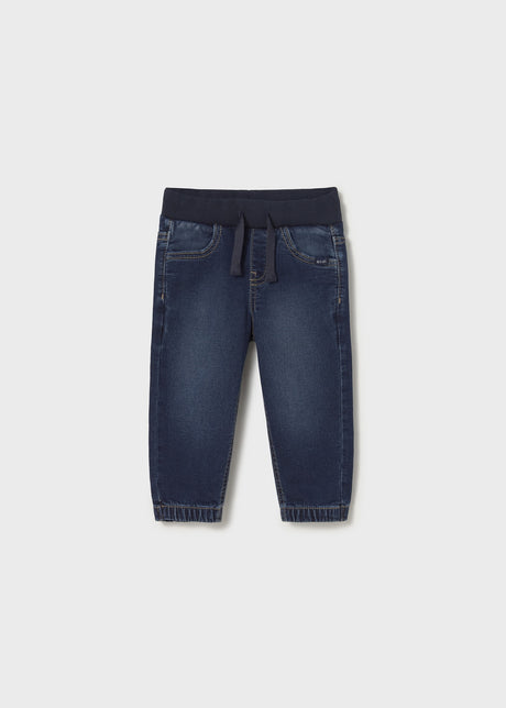 Front flat lay of dark denim jogger baby jeans showing tapered ankle.