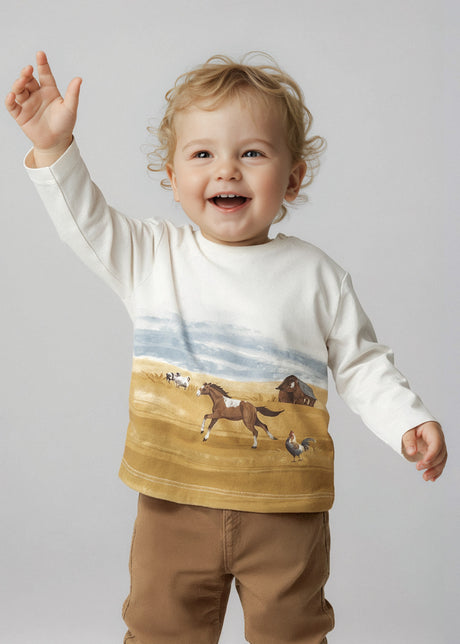 Toddler wearing farm-print long-sleeve tee, everyday outfit.