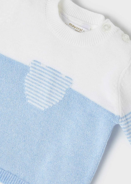 Closeup of fine-gauge knit and chest pocket detail on jumper.