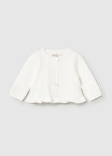 Front view Ivory newborn cardigan with ruffle hem and button closure