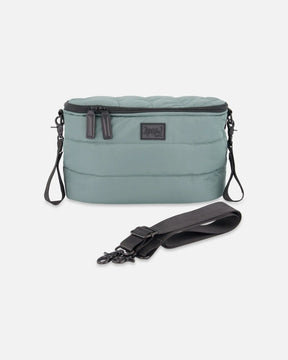 Quilted mini diaper bag for strollers in sage green with black stroller clips and a detachable shoulder strap
