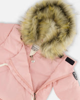 Flat lay — pink one-piece pram suit with detachable faux-fur hood, ready to ship — buy now.