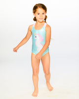 Studio full-body view of girl in aqua seahorse one-piece swimsuit
