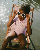 Girl posing with sunglasses in purple floral swimsuit from Like A Fish To Water collection