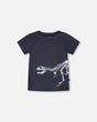 Front flat lay of Deux par Deux boy short sleeve kids rashguard in black with dinosaur skeleton print