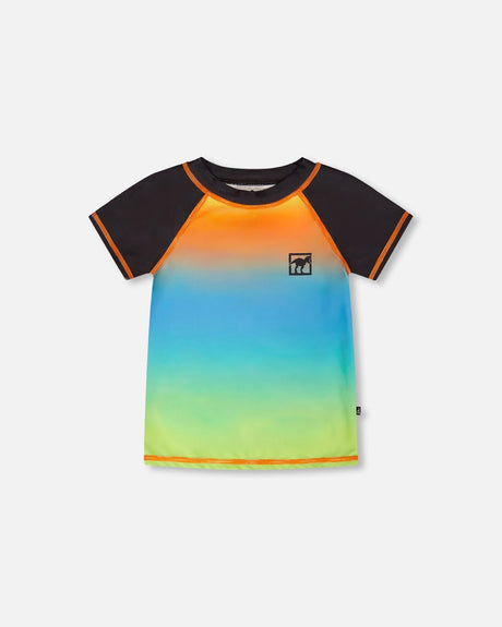 Front flat lay of Deux par Deux baby and boy short sleeve rashguard in orange blue green gradient