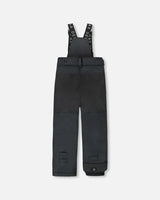 Front view of black bib snow pants, insulated, ankle snow guards.