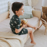 Toddler boy wearing military green safari jeep pajama set by Petit Lem