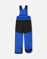 Blue bib pants with Cordura® panels, articulated knees, and removable suspenders.