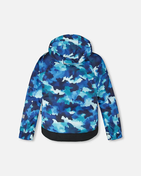 Back view of jacket and snow pants set with detachable hood and snow skirt, blue camo/orange.