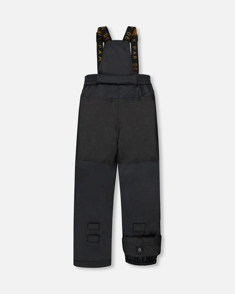 Black bib pants with Cordura knees and ankle gaiters, two-piece ski suit.
