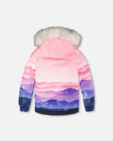 Back view of gradient jacket with faux-fur hood and snow skirt — two-piece ski suit.