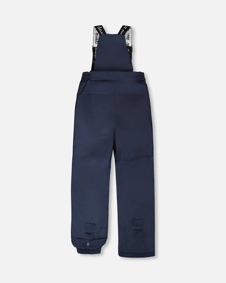 Navy bib pants with Cordura knees/seat and ankle gaiters — jacket and snow pants bottom.
