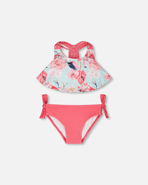Flat lay of Deux par Deux girl blue flamingo print two-piece swimsuit with pink bottoms