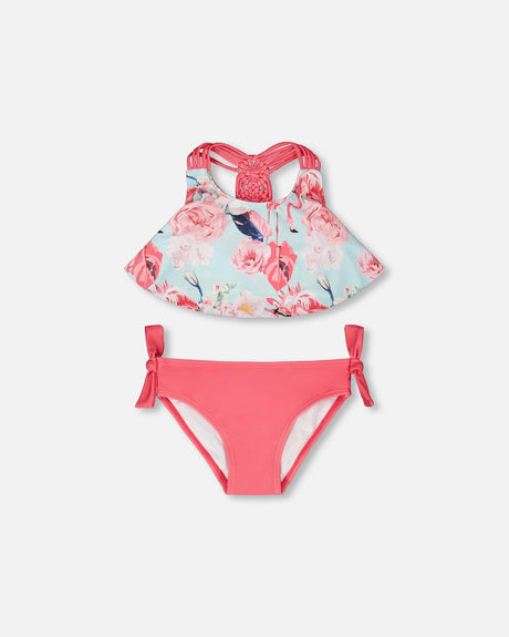 Flat lay of Deux par Deux girl blue flamingo print two-piece swimsuit with pink bottoms