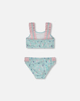 Flat view of Deux par Deux girls two-piece swimsuit showing frilled top and seahorse swim bottoms.