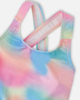 Closeup of Deux par Deux swimsuit showing crossed back straps and pastel multicolor swim top.