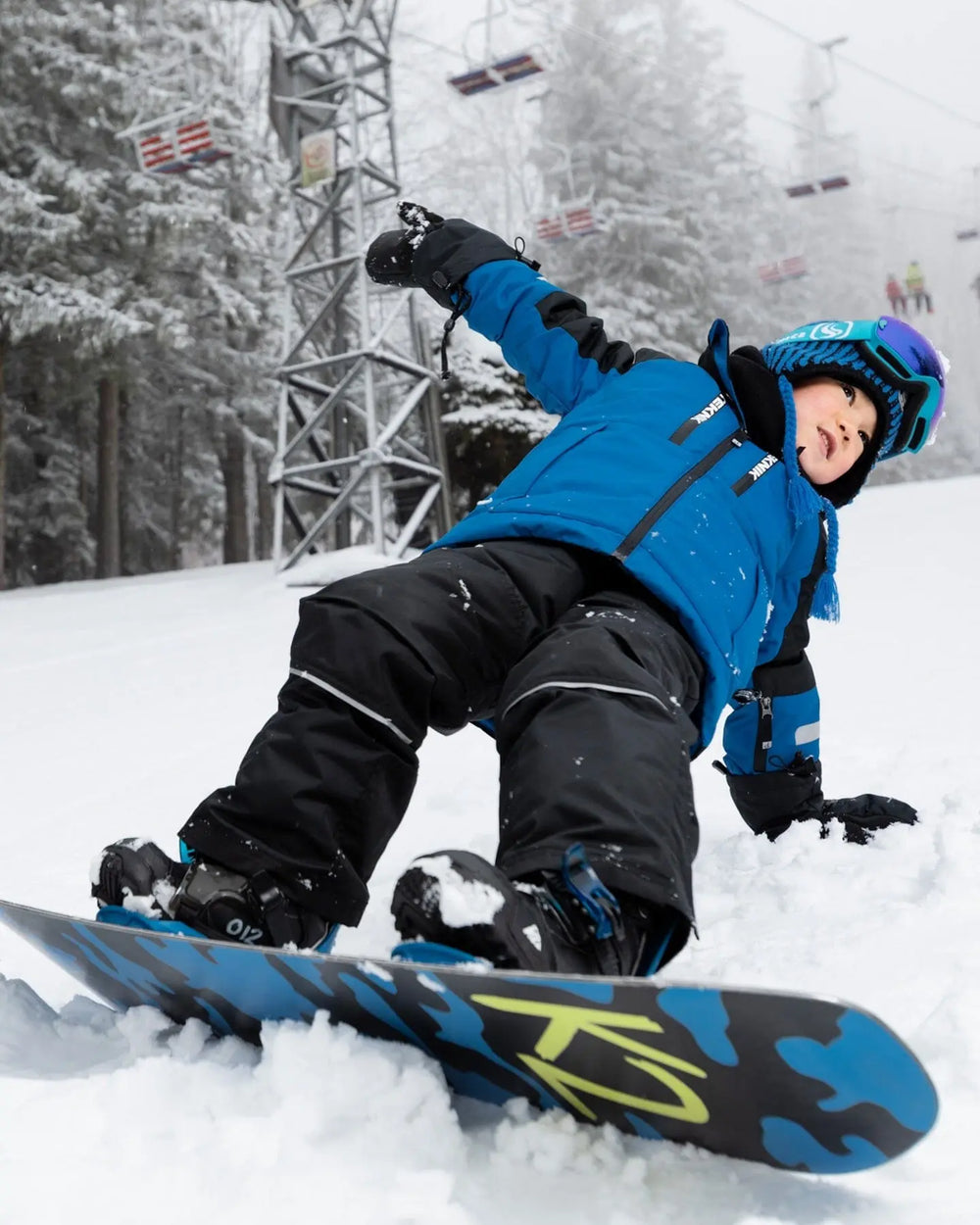Snowboarding pose showing articulated knees, kids winter suit