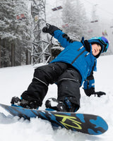 Snowboarding pose showing articulated knees, kids winter suit