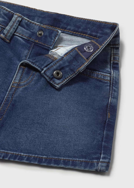 Closeup of adjustable waistband and denim fabric on baby boy shorts.