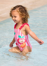 Baby girl wearing Mayoral Pink graphic swimsuit for pool and summer water play.