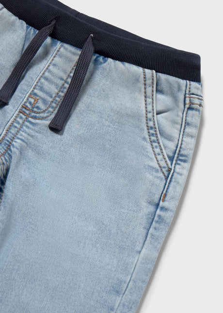 Closeup of Mayoral elastic waist baby jeans showing drawstring, pocket detail, and soft denim texture.