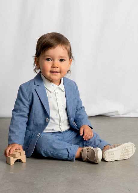 Sitting baby in Mayoral baby boy blazer styled for family photos and dressy events.