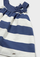 Closeup of Mayoral baby girl cotton dress showing Navy/White stripes and decorative flower detail.
