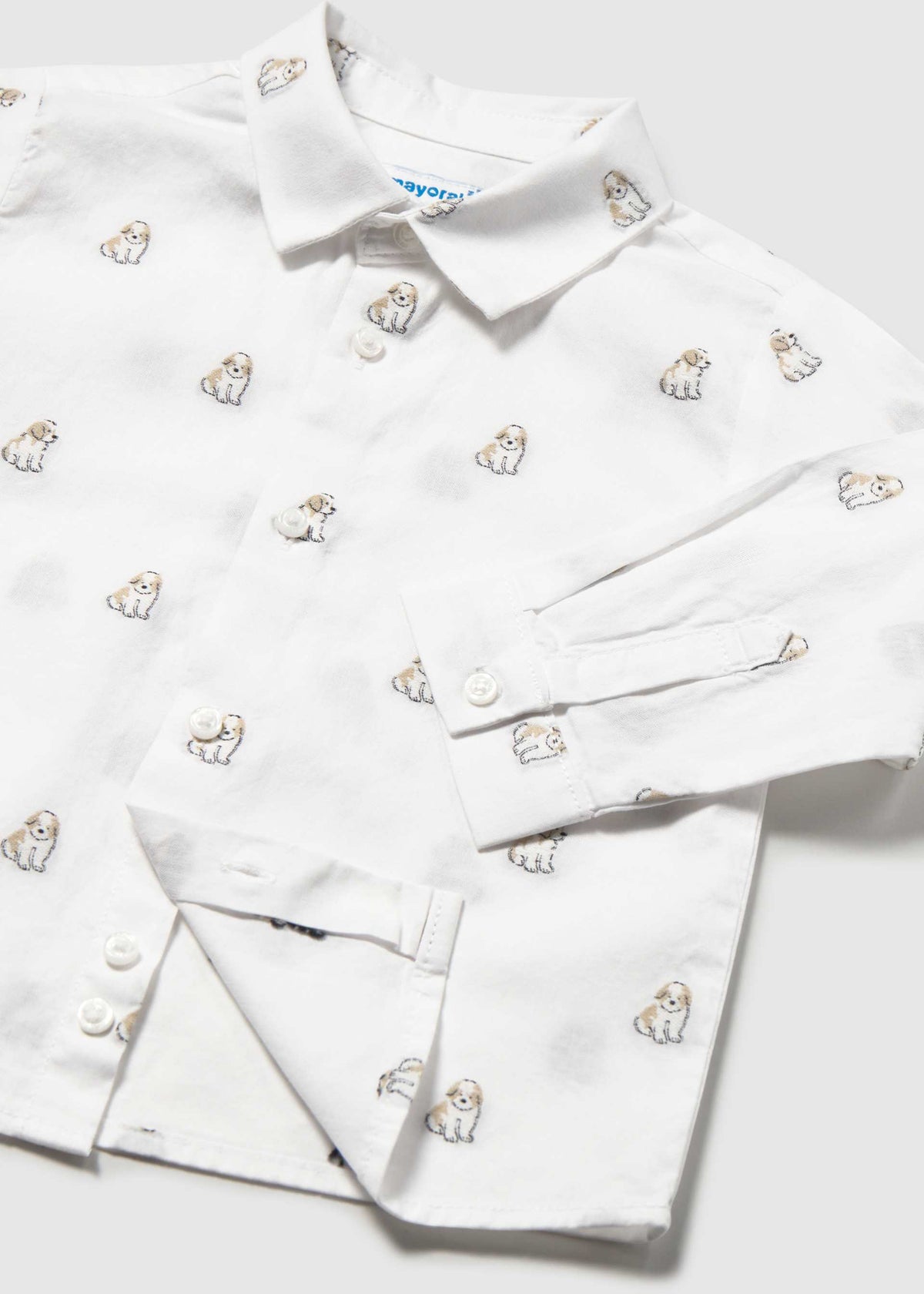 Close-up of the collar, buttons and small dog print on the white shirt
