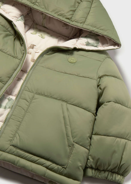 Close-up of Mayoral baby boy reversible puffer jacket showing dinosaur print lining, Olive Green side, and quilted detail.