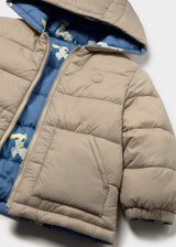 Close-up of Mayoral baby boy reversible puffer jacket showing Blue printed side, Taupe reverse side, and quilted lining detail.