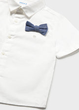 Closeup of Mayoral white short-sleeve shirt with button front and navy bow tie detail.