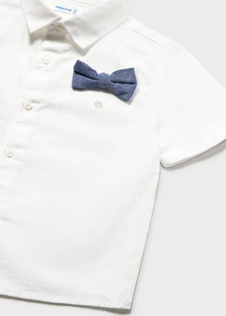 Closeup of Mayoral white short-sleeve shirt with button front and navy bow tie detail.
