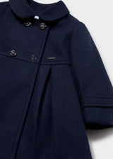 Close-up of four buttons and the round collar on the navy double-breasted coat