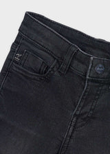 Close-up of the waistband, button and front pocket on the black jeans