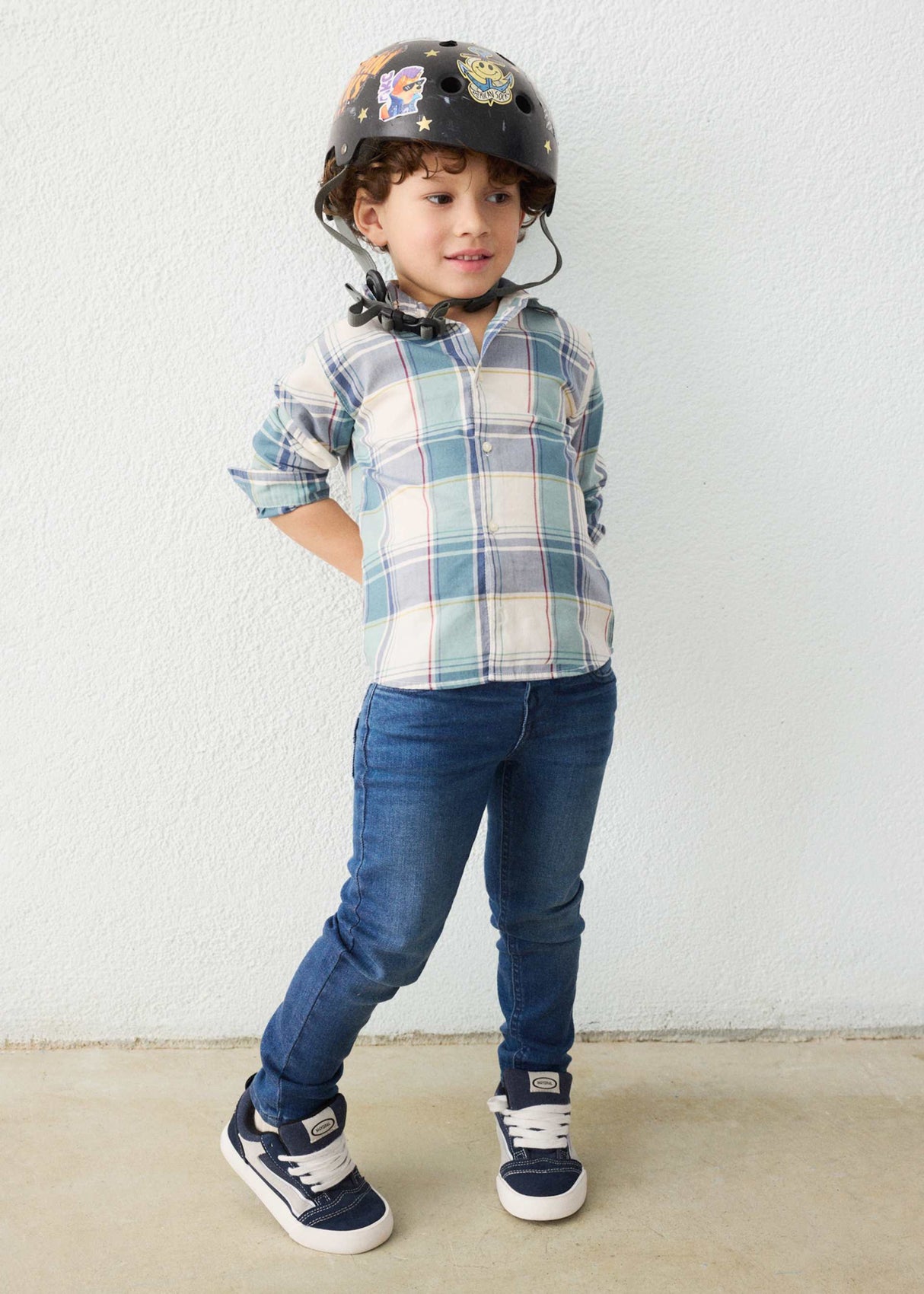 Boy wearing Mayoral slim fit jeans with casual shirt, sneakers, and everyday school style.