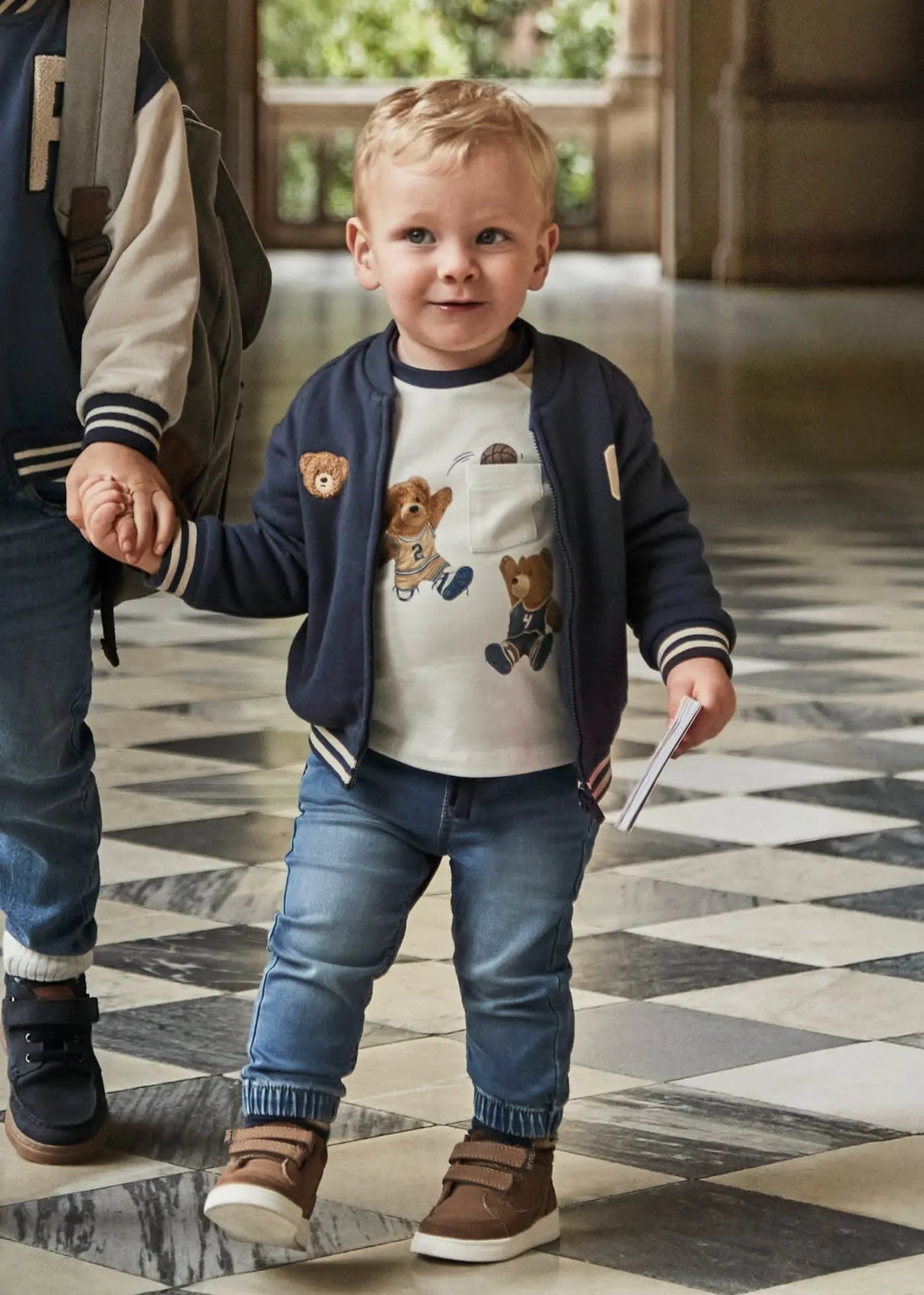 Toddler wearing Mayoral baby denim jogger pants, tapered legs for easy movement